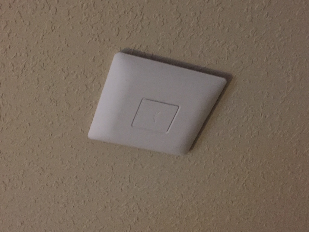 Ubiquiti UniFi UAP-AC installed on the ceiling of the main room in my house, near the center. It's just a little bit larger than a smoke detector.